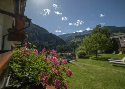 Vista dal balcone di Casa Bamby sui gerani e sulle montagne della Val di Peio